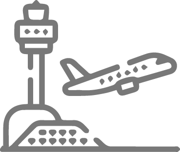 Gray icon of an airport with a control tower and an airplane taking off, representing air travel.