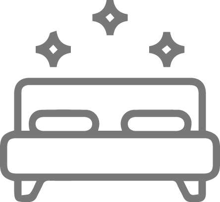 Gray icon of a bed with sparkles, representing clean or premium accommodations.